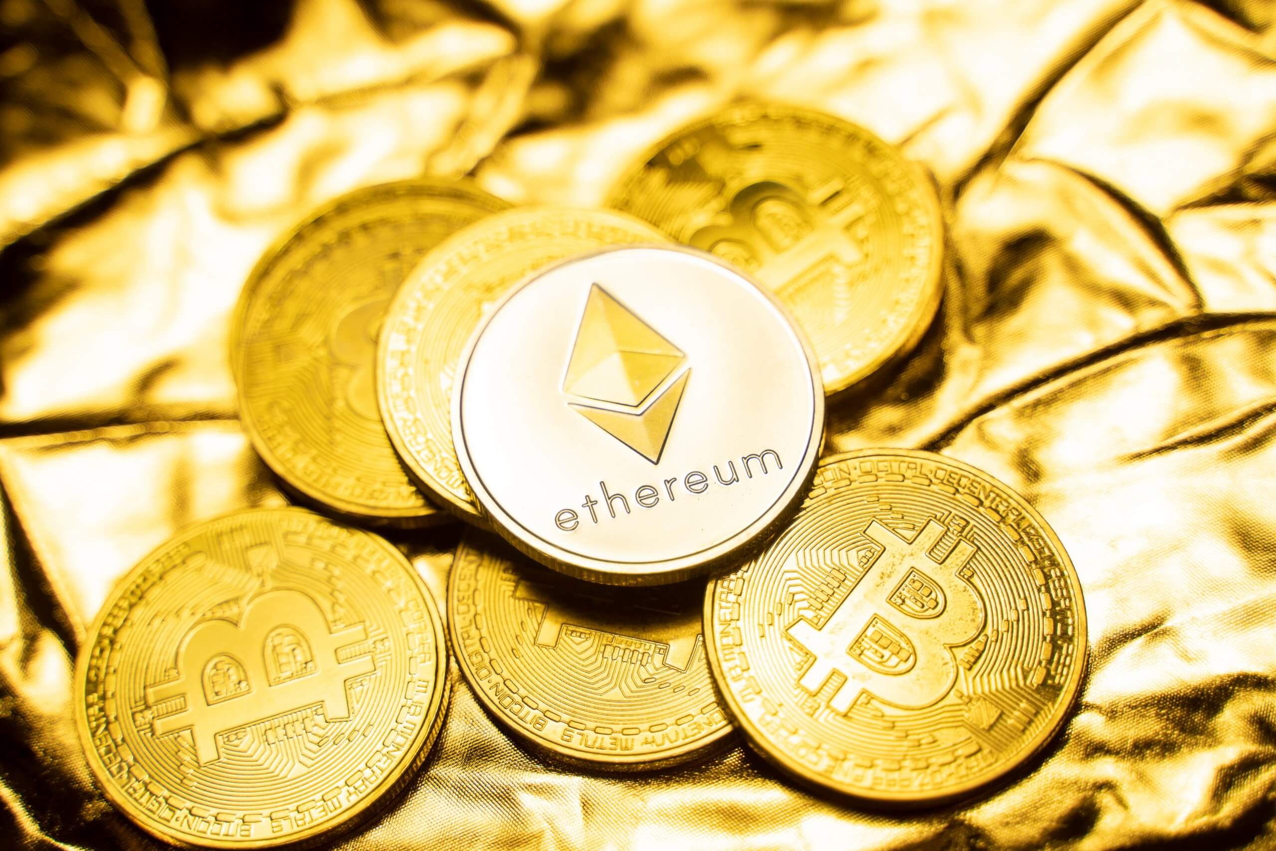 Gold,Ethereum,Coins,On,A,Golden,Background.,Trading,On,The